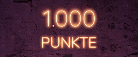 Leuchtende 1.000 Punkte auf dunklem Hintergrund - Belohnung und Erfolg erleben!