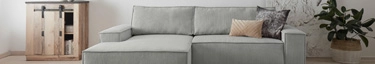 Elegantes graues Sofa in modernem Wohnzimmer, stilvoll und einladend.